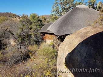 Thatched Mhlangeni Bush Camp accommodation nestled among granite boulders