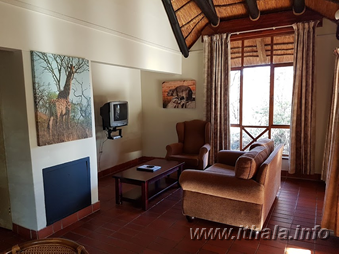 Lounge inside a two-sleeper self-catering chalet at Ntshondwe Camp