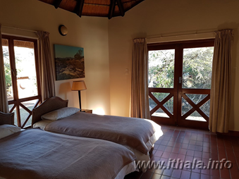 Twin bedroom in a two-sleeper non-self-catering chalet at Ntshondwe Camp