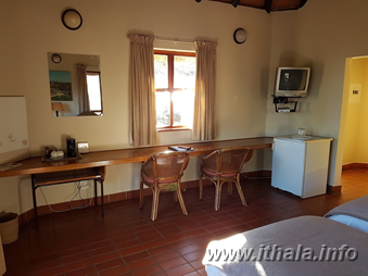 Counter and bar fridge inside a two-sleeper chalet at Ntshondwe Camp