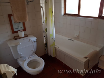 Private bathroom with bath and toilet in a two-sleeper chalet at Ntshondwe Camp