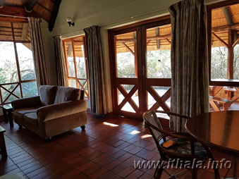 Chalet lounge opening onto a private veranda at Ntshondwe Camp