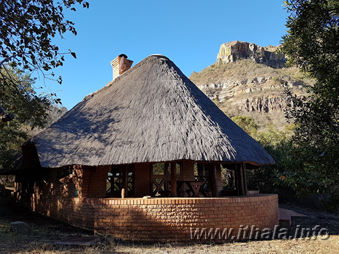 Exterior of a four-sleeper thatched chalet at Ntshondwe Camp in Ithala Game Reserve