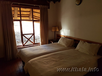 Double bedroom in a four-sleeper chalet at Ntshondwe Camp in Ithala Game Reserve
