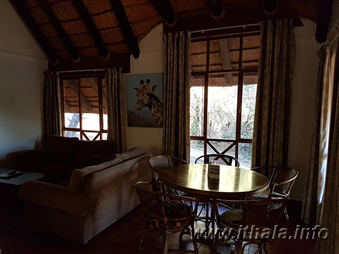Lounge and dining area in a four-sleeper chalet at Ntshondwe Camp, Ithala Game Reserve