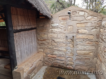 Private outdoor shower with stone walls at Thalu Bush Camp