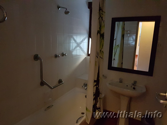 Bathroom with shower and washbasin in a six-bed chalet at Ntshondwe Camp