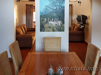 Open-plan living area inside a six-bed chalet at Ntshondwe Camp