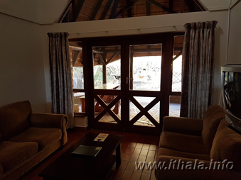 Covered wooden veranda with bush views at a Ntshondwe Camp chalet