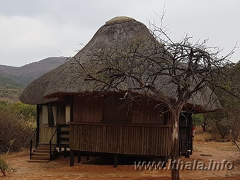 Exterior of a thatched wooden cabin at Mbizo Bush Camp
